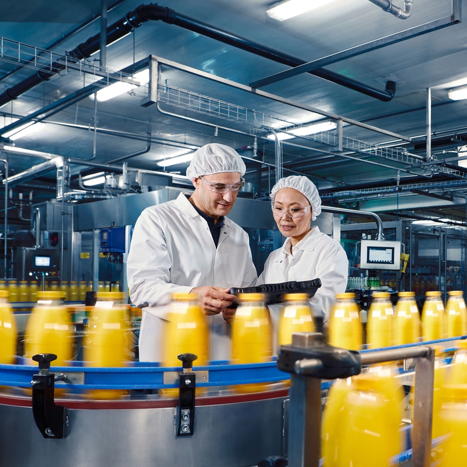 Worker standing in front of a beverage production