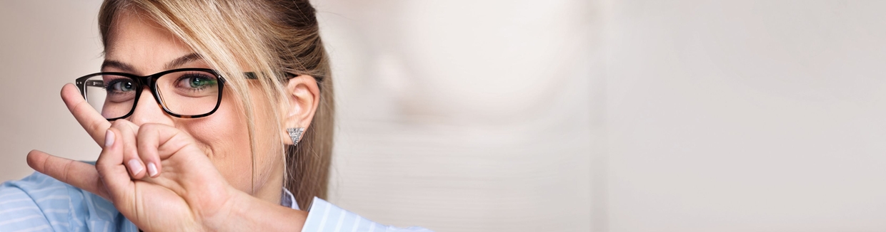 Woman with glasses smiling into camera