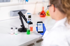 Monitor grab samples in the maintenance workshop or laboratory Laboratory employee examining grab samples in the lab