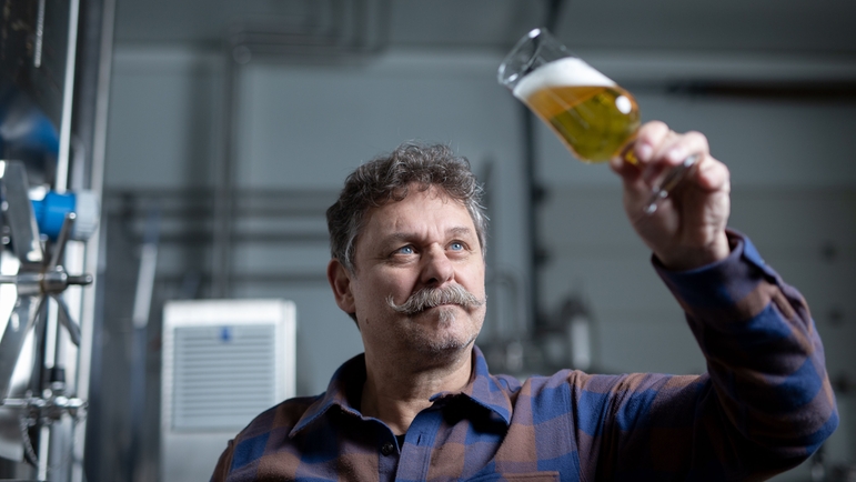 Brewer holding beer