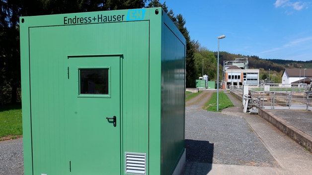 Container with measuring instrument inside